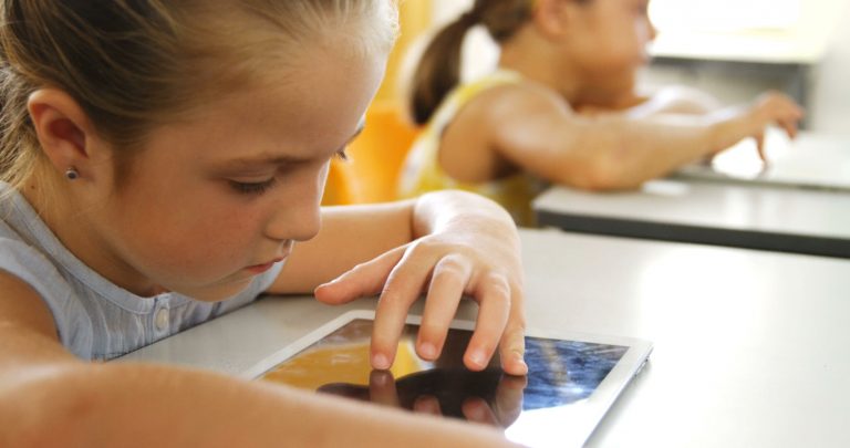 Children learning on tablets